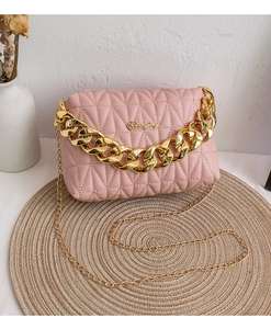 Detail of pink quilted leather crossbody bag with gold logo and dual chain straps