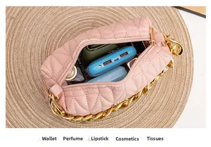 Detail showing the spacious interior of pink quilted handbag with gold chain accent