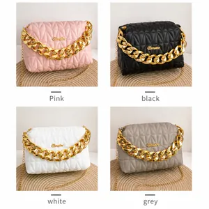 Quilted crossbody bags in pink, black, white, and grey with chunky gold chain handles