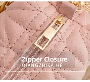 Detail of pink quilted leather handbag featuring smooth gold zipper and diamond stitch texture