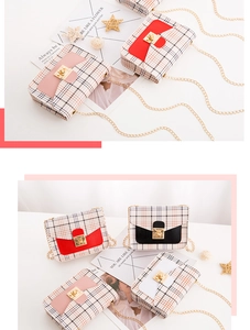 Close-up of stylish plaid pattern texture and gold metal twist lock on the flap bag