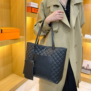 Chic black quilted tote bag with matching mini pouch and long shoulder straps