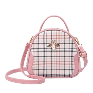 Pink and beige plaid handbag with gold bee buckle and adjustable shoulder strap