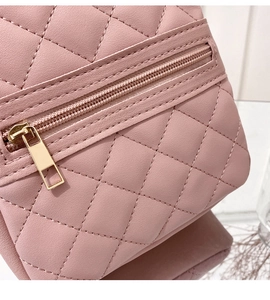 Detail of pink quilted leather texture with golden metal zipper on fashion bag
