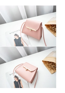 Detailed view of pink matte leather crossbody bag with elegant gold metal lock clasp