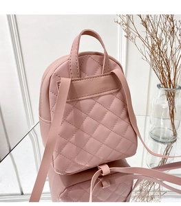 Detailed back view of pink quilted mini backpack with adjustable thin shoulder straps
