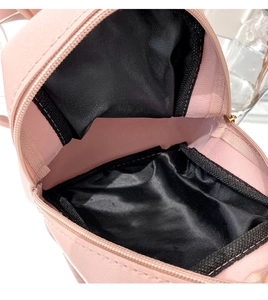 Macro view of the pink quilted mini backpack showing the spacious interior and black lining