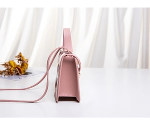 Side view of elegant pink crossbody bag with textured leather and adjustable strap