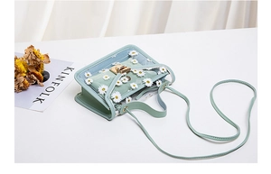 Detail of light green transparent crossbody bag with daisy floral prints and inner pouch