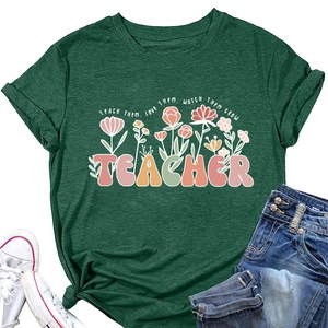 Détail d'un t-shirt vert foncé avec motif floral, slogan et manches retroussées