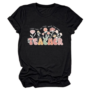 Détail de l'imprimé floral et texte TEACH THEM sur t-shirt noir pour enseignante