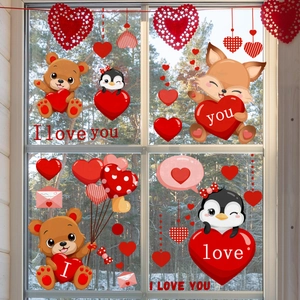 Valentine window stickers featuring cartoon bears, foxes and hearts on glass with snow view