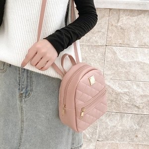 Pink quilted faux leather mini crossbody bag with diamond patterns and gold hardware