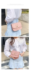 Detailed view of pink quilted chain bag with gold twist lock and gradient edge finish