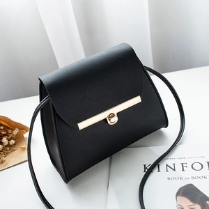 Minimalist black pebble leather mini crossbody bag with golden metal twist lock closure