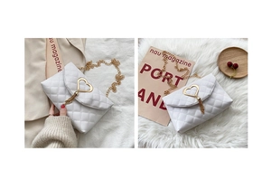 Macro shot of white quilted crossbody bag with golden heart lock and tassel details