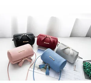 Chic cylindrical crossbody bags in five colors with bow zipper and lychee texture