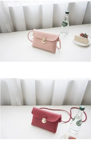 Detail view of mini crossbody bags in pink and wine red with gold circular metal clasps