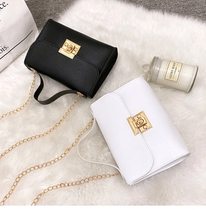 Detail of elegant black and white flap bags with golden square locks and chain straps