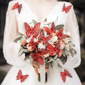 Detail of red hollow glitter butterfly stickers on a wedding dress with floral background