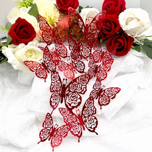 Close-up of red hollowed butterfly stickers with rose pattern and glitter finish