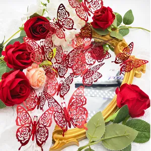 Close-up of red 3D butterfly wall decals with rose pattern hollow design and glitter