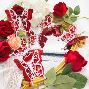 Detailed 3D hollow butterfly wall stickers with red and silver glitter in a floral setting