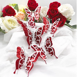 Close-up of 3D red glitter and silver hollow butterflies on white tulle with roses