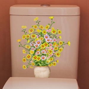 Detail of yellow daisy flower vase decal applied on a pink ceramic bathroom toilet tank