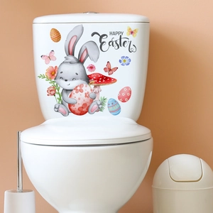 Close-up of Easter toilet stickers with cartoon rabbit, eggs and Happy Easter lettering