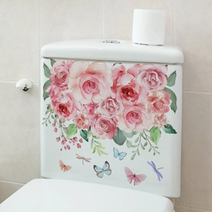 Detail of pink rose and butterfly floral decals on a white ceramic toilet tank