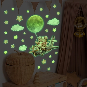 Luminous wall stickers featuring cartoon bear flying a plane with moon and stars