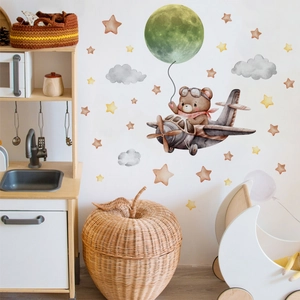 Nursery wall decals featuring cartoon bear flying plane with moon and star stickers