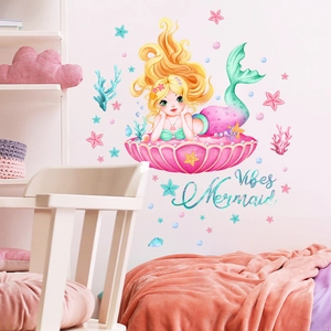 Detailed view of mermaid wall stickers with shells and stars in a cozy girl bedroom