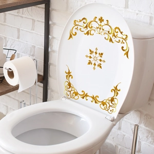 Nahaufnahme goldener Vintage-Scroll-Muster auf weißem Toilettendeckel-Dekorsticker