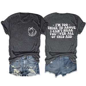 Flat lay of gray T-shirt with 'TOO THICK TO ARGUE' quote and distressed denim shorts
