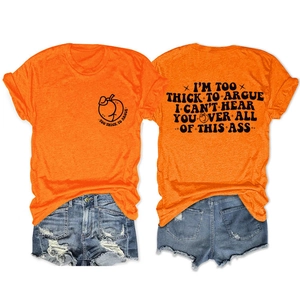 Flat lay of orange t-shirt with peach graphic and blue distressed denim shorts set