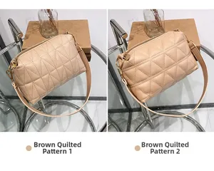 Détail de sacs bandoulière marron matelassés avec fines lanières et ferrures dorées