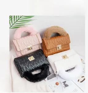 Close-up of quilted pattern and gold buckles on faux fur handle shoulder bags in four colors