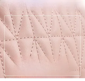 Detail shot of pink quilted leather featuring geometric triangular stitching patterns