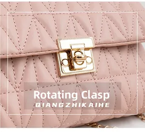 Detailed view of pink quilted handbag with gold turn-lock closure and metal chain strap