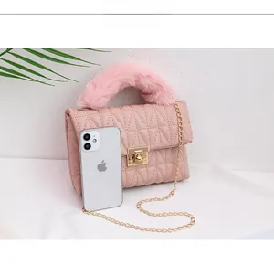 Pink quilted leather handbag detail with faux fur handle and gold metal chain strap
