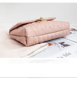 Detailed 45-degree angle of pink quilted bag with elegant gold twist-lock closure