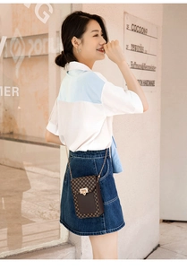 Close-up of geometric pattern chain bag shown on model for size and style reference