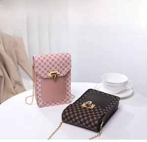 Detail of pink and brown crossbody phone bags with floral print and gold chain strap