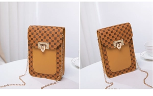 Detail of vintage geometric print handbag with golden twist lock and metal chain strap