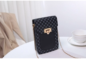 Detail view of mini crossbody bag with geometric print, gold lock, and chain strap