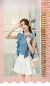 Close-up of beige and pink crocodile pattern crossbody bag with a blue ruffle top