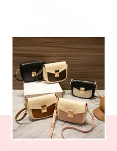 Detail showing various colors of crocodile embossed square bags with gold metal clasps