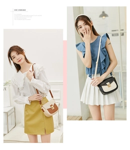 Close-up of color-block crocodile pattern crossbody bags with gold metal flip locks